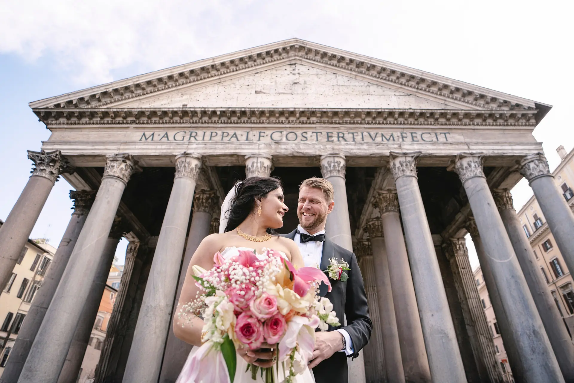 Happy couple posing for wedding photos at the Pantheon in Rome, showing how to get married in Italy as an American.